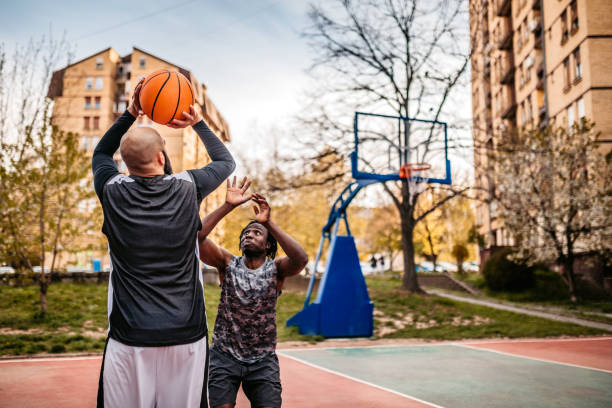 istock Man shooting on basketball hoop 1315224884