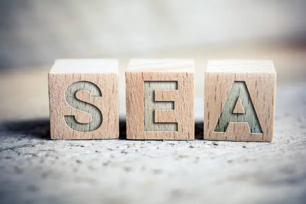 SEA Search Engine Advertising Written On Blocks On A Wooden Board - Business Marketing Concept