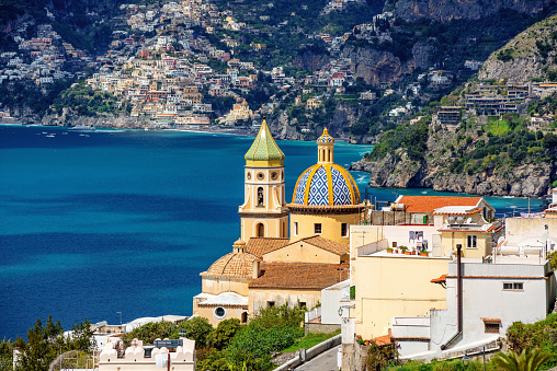 Praiano town on Amalfi coast, Mediterranean sea, Italy, view of the domes of San Gennaro church and Positano town