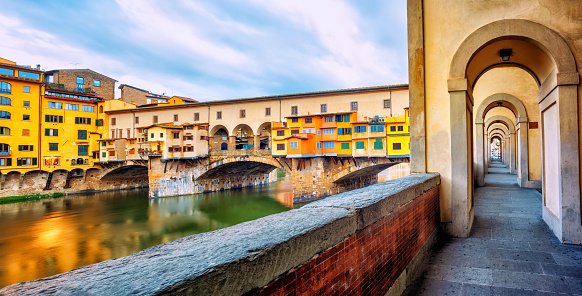 Ponte Vecchio historical bridge and the riverside promenade gallery in the Old town of Florence, Tuscany, Italy