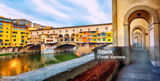 Ponte Vecchio Bridge And Riverside Promenade In Florence Italy Stock Photo - Download Image Now