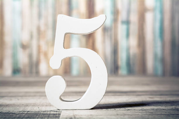 Number 5 Standing On Gray Wooden Board