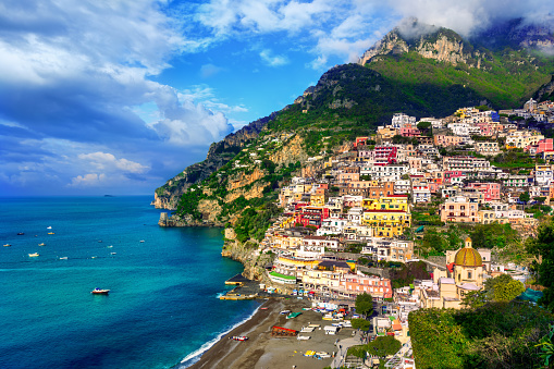 Positano, a town on Amalfi coast, Naples, Italy, dramatically set on a steep cliff between Mediterranean sea and mountains, is a famous travel destination and tourist resort in Italy