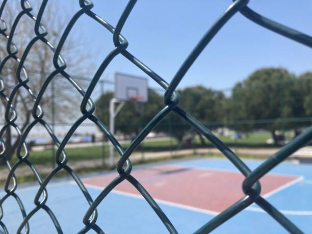 istock empty outdoors basketball court view behind fench 1315227972