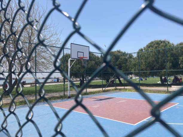 istock empty outdoors basketball court view behind fench 1315227996