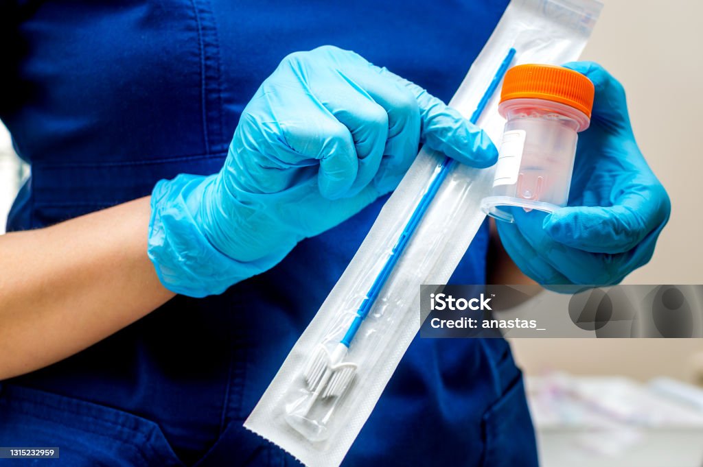 Gynecologist holds a brush for sampling liquid cytology Pap Smear Stock Photo