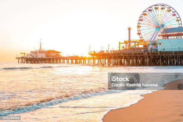 Santa Monica Pier On The Background Of An Orange Sunset Calm Ocean Waves Los Angeles California Stock Photo - Download Image Now