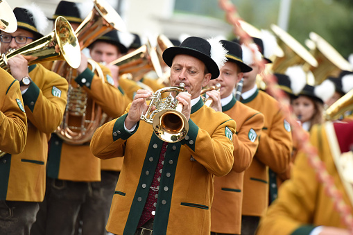 A brass band outdoors at the public festival of folk culture in Oberwang, Austria