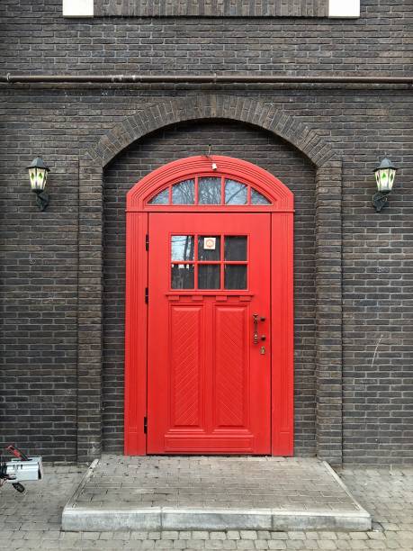 istock Beautiful red door in a brick wall 1315239935