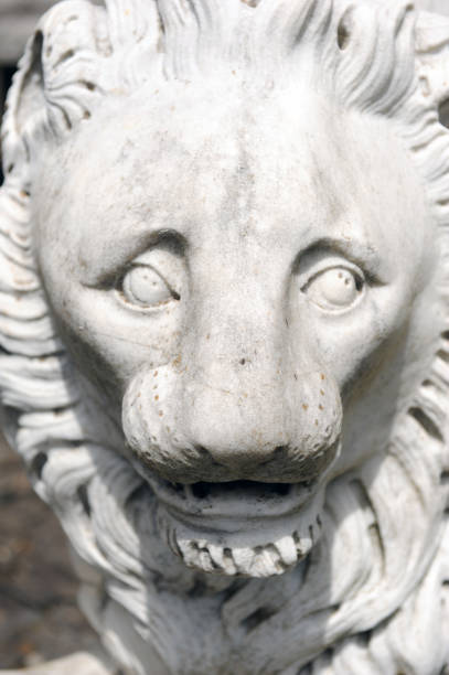 istock Stone lion face close up. Angry lion sculpture. 1315240350