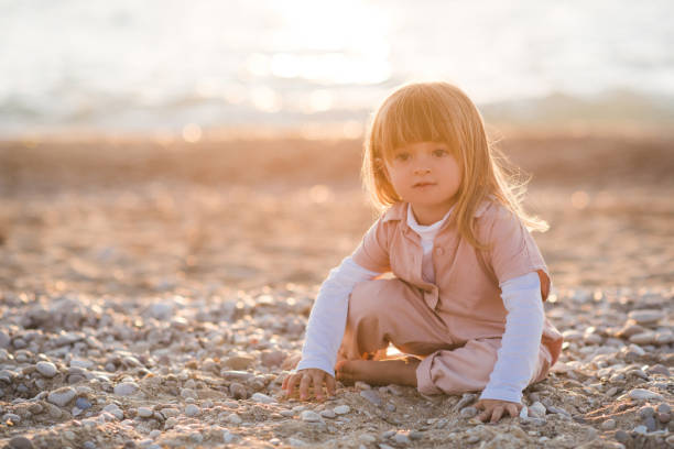 istock Kid girl having fun at beach outdoors 1315242582
