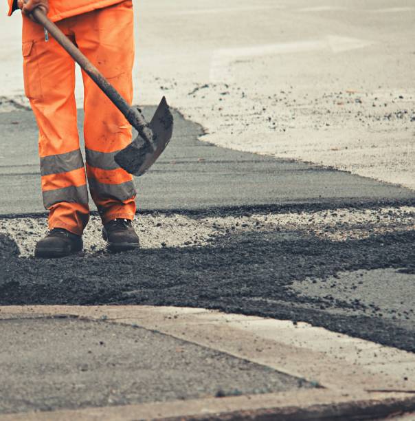 istock Man at work while repairing a street 1315243820
