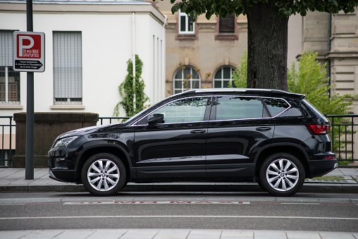 Mulhouse - France - 29 April 2021 - Profile view of black Seat ateca SUV car parked in the street