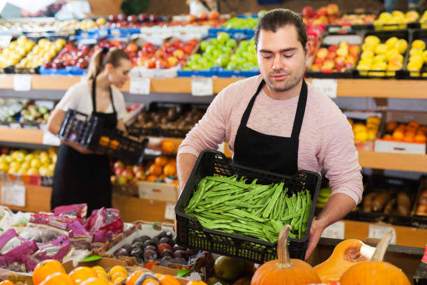 istock Seller with beans in greengrocery 1315246572