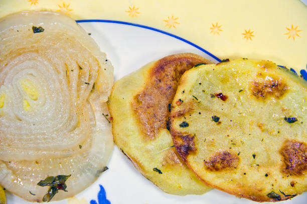 istock Baked potatoes and onion on fresh vegetables 1315247635
