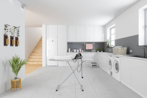 istock Laundry Room With Washing Machine, Dryer, Ironing Board And White Cabinets 1315248668