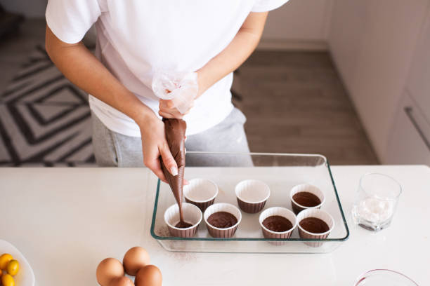 istock Woman making chocolate cupcakes indoors 1315248783