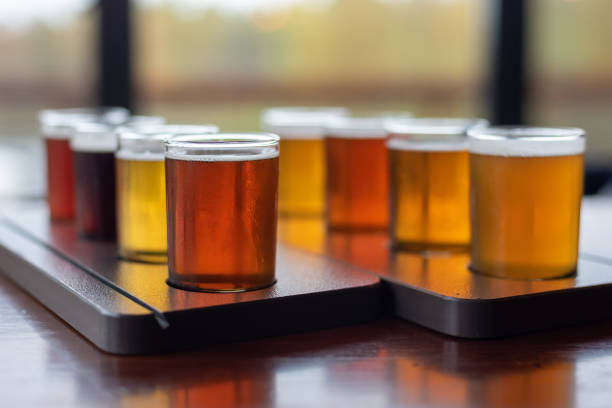 Beautiful variety of craft beer samples on a restaurant table Craft beer samples in a variety of styles and flavors craft beer stock pictures, royalty-free photos & images