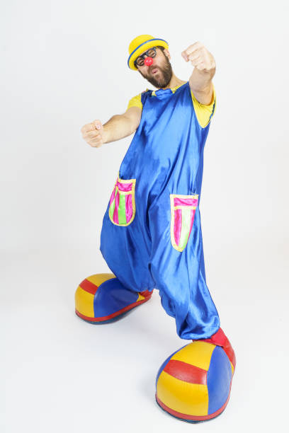 istock A clown in a bright blue and yellow suit virtually driving a car 1315249799