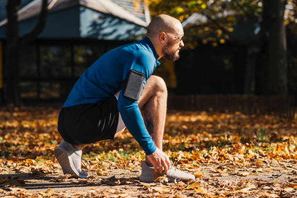 istock Young Man Tying his Shoelace while Running in the Park 1315251290