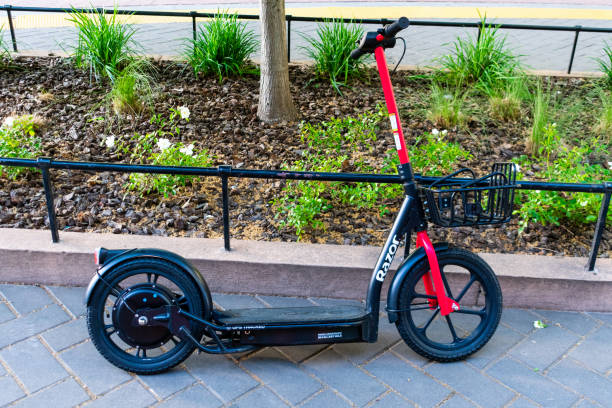 Side view of an empty Razor Share electric rideshare e-scooter parked on the sidewalk - Sacramento, California, USA - 2021