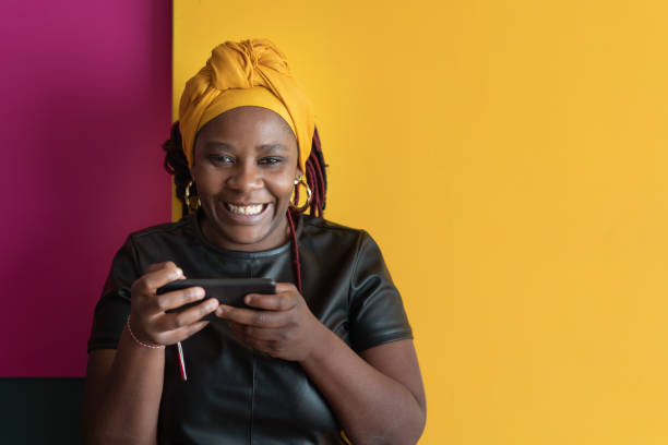 Portrait of a black woman on a yellow background stock photo