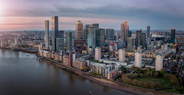Panoramic view of the residential and commercial skyscrapers of Canary Wharf, London Panoramic view of the residential and commercial skyscrapers of Canary Wharf and the Docklands in London, United Kingdom, during sunset time canary wharf photos stock pictures, royalty-free photos & images