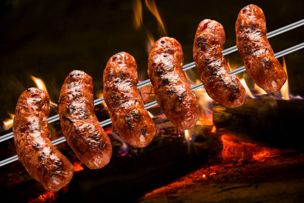 istock Sausages on the barbecue spit with flames 1315255161