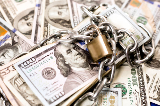 istock American paper currency under lock and chain. 1315255718
