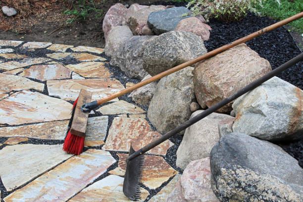 istock A rake and broom used on patio stones 1315256907