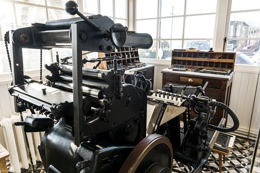 A small print shop that prints the old-fashioned way.   The printing machine is a classic old brand Heidelberg.