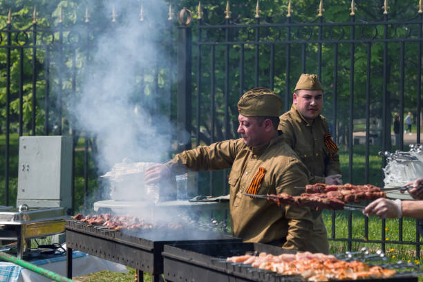 Victory Day celebration in Russia. Traditional cooking of shish kebabs. stock photo