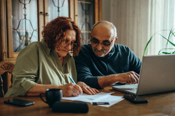 istock Senior couple using a laptop while doing their finances at home 1315259734