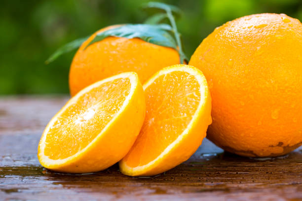 istock Sweet fresh oranges in natural light on old wood 1315259911
