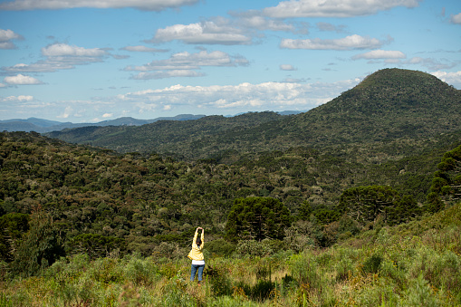 Woman enjoying the outdoors with this stunning landscape with the mountains and canyons at the Serra Catarinense