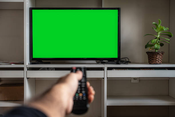 Remote control and LCD screen TV - Chroma Key Pointing remote control towards a TV at home- Chroma Key chroma key stock pictures, royalty-free photos & images