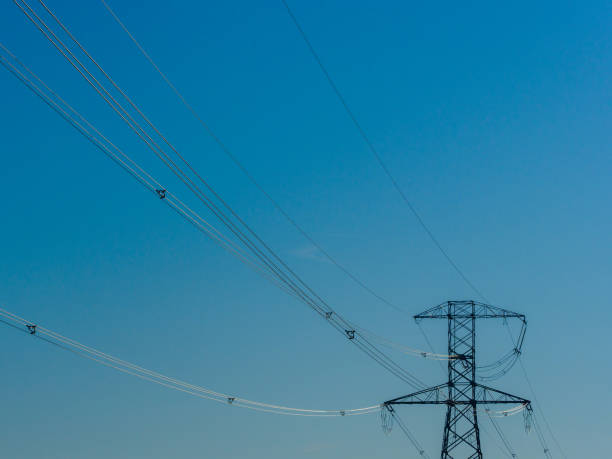 istock Electric pole and high voltage cable from power plant 1315262330
