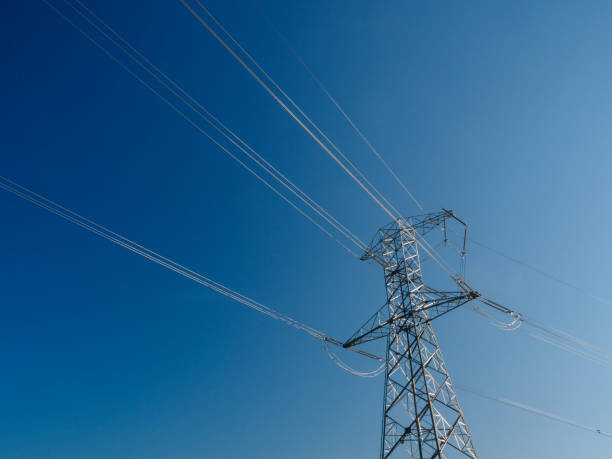 istock Electric pole and high voltage cable from power plant 1315262346