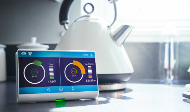 Smart meter in kitchen A smart meter on a kitchen work surface showing the households current energy consumption and costs energy bill photos stock pictures, royalty-free photos & images