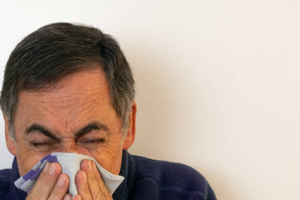 Mister sneezing heavily sick with flu and white copy space