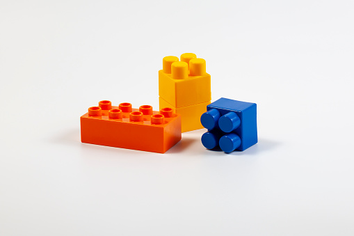 Multicolored blocks of children's constructor on a white background.