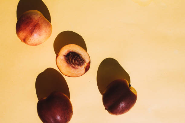 istock tree pieces of peach on yellow background 1315278821