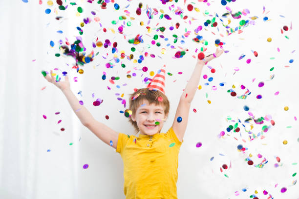 istock happy child boy with confetti on white background 1315293332