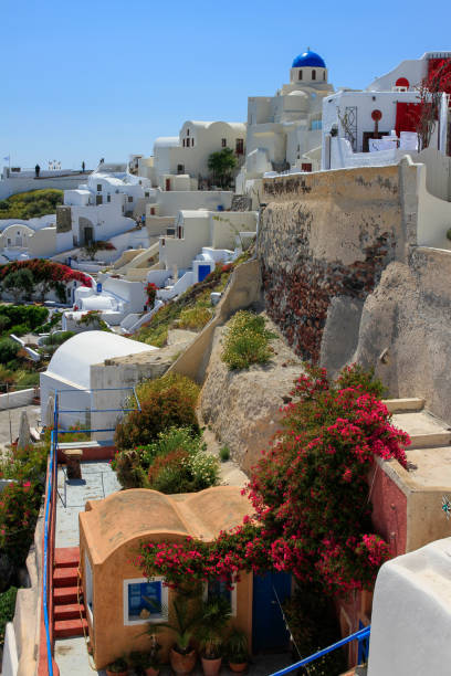istock Whitewashed residences and blue dome on hillside of Oia, Santorini, Greece 1315293373