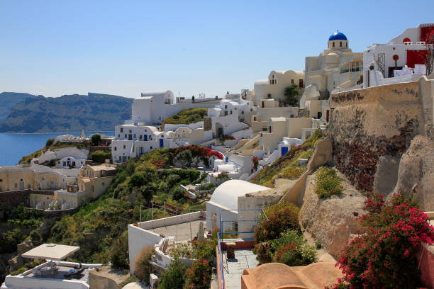 istock Whitewashed residences and blue dome on hillside of Oia, Santorini, Greece 1315293821