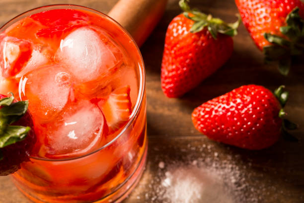 istock Fresh made Strawberry Caipirinha on wooden background 1315298907