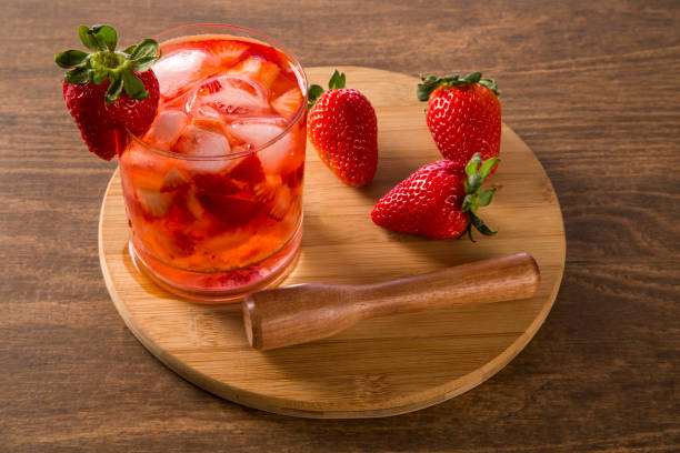 istock Fresh made Strawberry Caipirinha on wooden background 1315299109