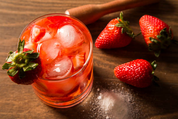 istock Fresh made Strawberry Caipirinha on wooden background 1315299842