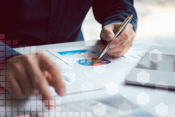 istock Business people or accountants are analyzing graphs on finance, investment, graph chart hologram in front, business strategy ideas, data analysis technology. 1315302173