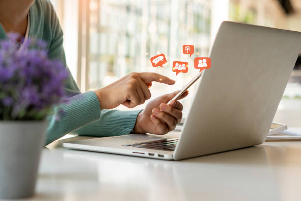 istock Young woman's hand is using a smartphone to play social media, a mobile phone with a notification icon,Social Distancing ,Working From Home concept. 1315302894
